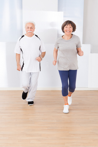 Senior Couple Jogging At Gym - Photo, Image