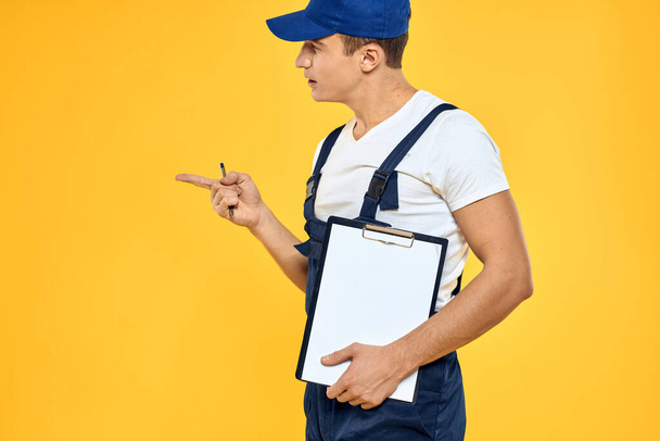 Man working uniform service professionals work yellow background - Фото, изображение