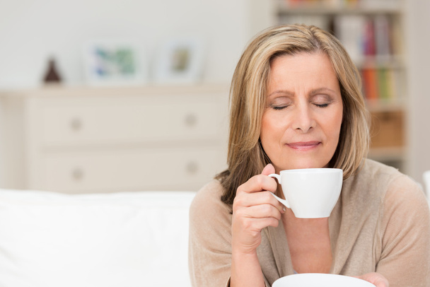 Woman enjoying an aromatic cup of coffee - Photo, image