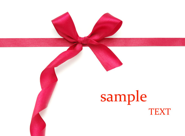 Red satin ribbon on white with shallow dof. - Photo, Image