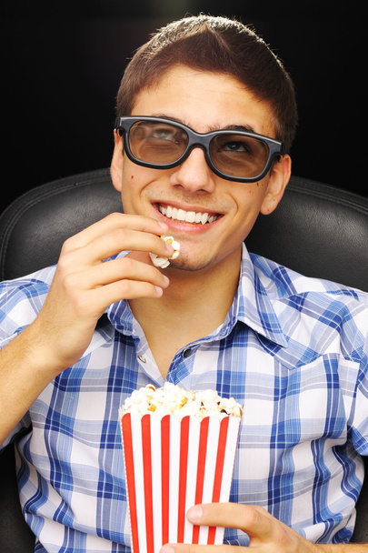 Young man at cinema - Фото, изображение