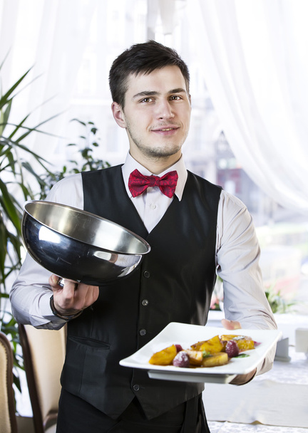 Waiter with a tray of food - Photo, image