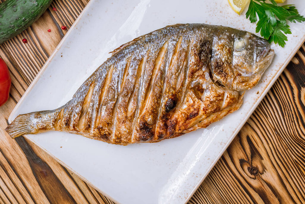 Closeup view of Dorado fish prepared on grill  - Foto, Bild