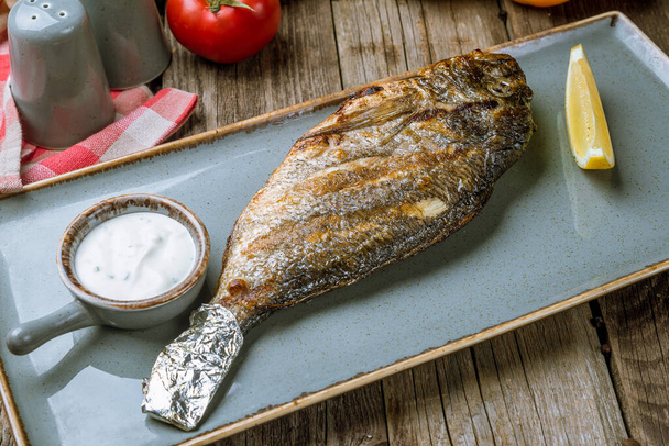 Closeup view of Dorado fish prepared on grill  - Photo, Image
