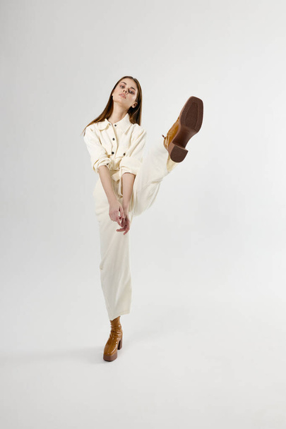 pretty woman wearing suit brown shoes leg raised up studio - Photo, Image
