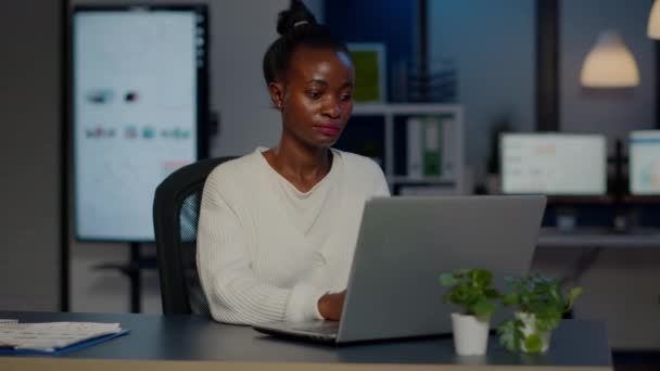 Businesswoman psaní e-mail pozdě v noci a dívá se do kamery - Záběry, video