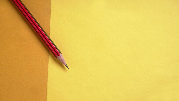 Pencil isolated on yellow background. - Foto, imagen
