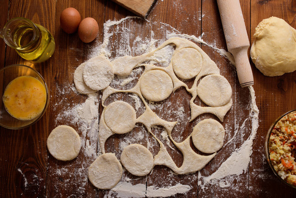 The dough is divided into circles. Homemade baking. - Photo, Image