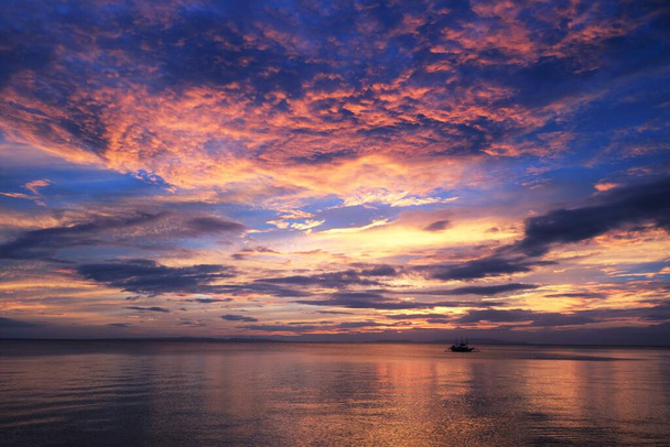 Úžasné barevné nebe s místní rybářské lodi míří ven - Fotografie, Obrázek
