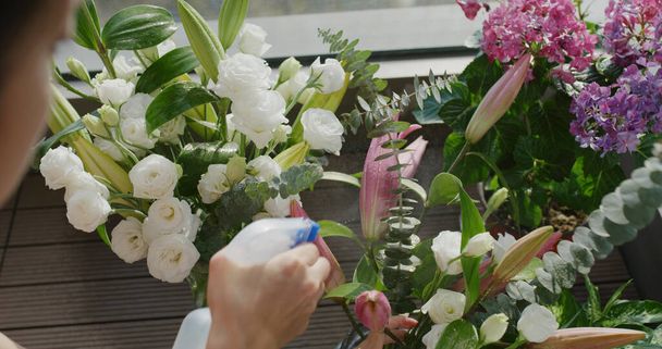 Woman watering her flower at home in balcony - Fotografie, Obrázek