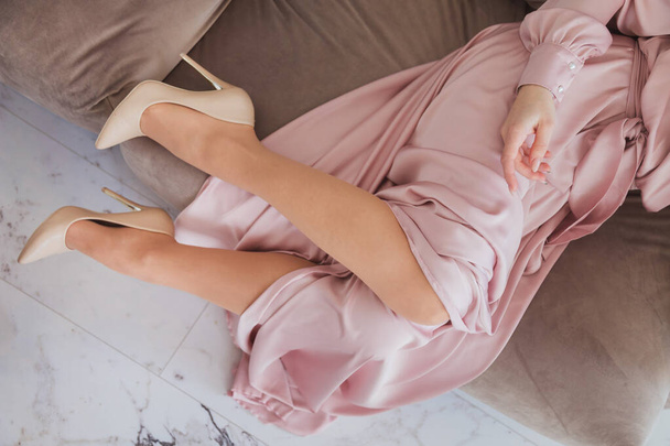 Perfect female legs wearing high heels. Holidays and relaxation concept - 写真・画像