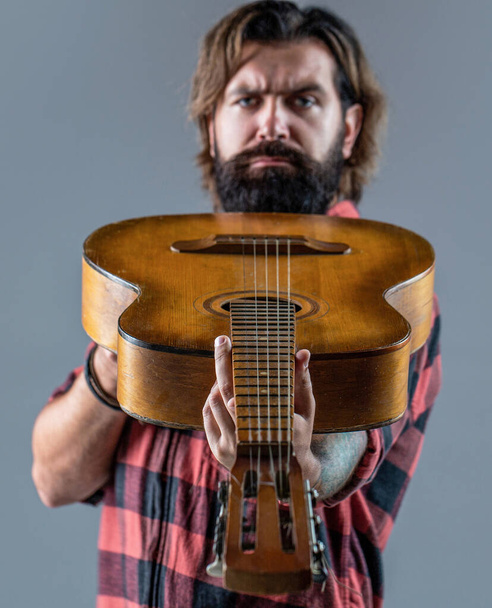 Guitars and strings. Music concept. Bearded guitarist plays. Play the guitar - Photo, Image