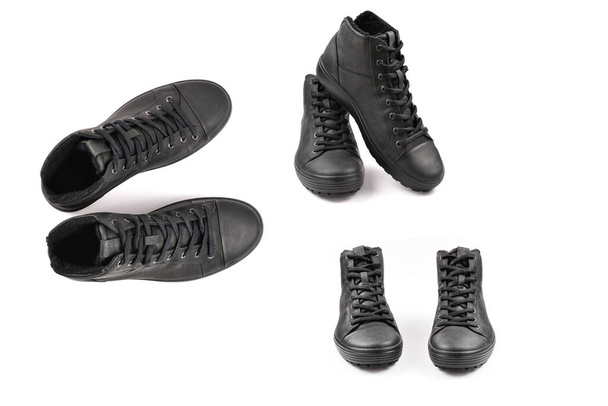 men's black leather shoes and a black camera on a black background. Copy space. - Photo, Image
