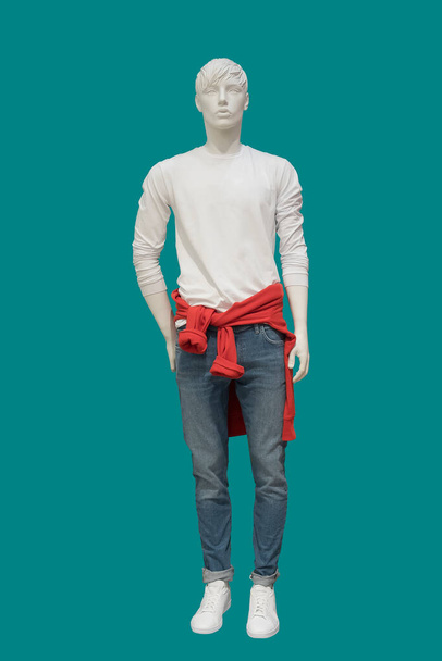 Full length image of a male display mannequin wearing long sleeve t-shirt isolated on a blue background. - Photo, Image