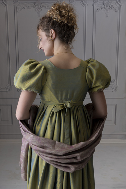 A Young Regency woman wearing a green shot silk gown and shown in back view - Photo, Image