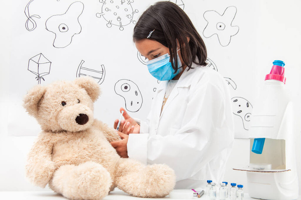 Young girl vaccinating. Young girl playing a life sciences professional role. Could be biologist, doctor, researcher, veterinary. Dreaming about the future. - Photo, Image