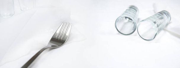 πιρούνι και δύο ποτήρι σε λευκό τραπεζομάντιλο τροφίμων και ποτών banner φόντο  - Φωτογραφία, εικόνα
