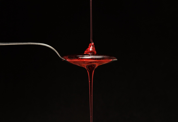 syrup spilling into a spoon - Foto, Imagem