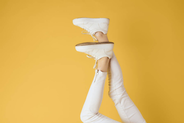 Inverted womens legs sneakers fashion studio street style - Fotografie, Obrázek