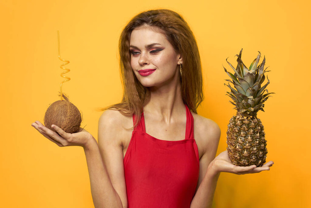 Pretty woman exotic fruits summer luxury yellow background - Foto, Imagen