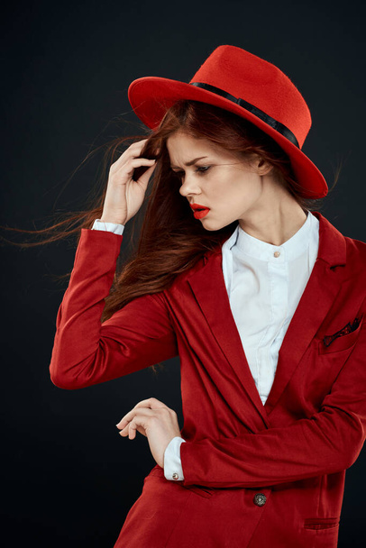 Cute red-haired woman elegant style red jacket black background - Foto, Bild