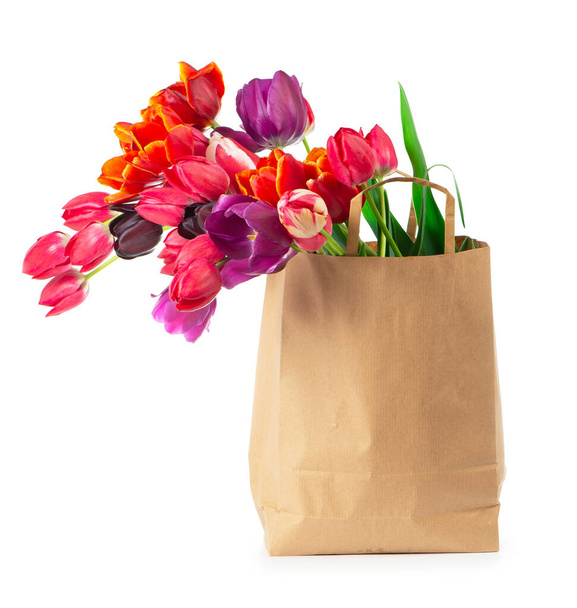 colorful tulips in a paper bag on a white background - Fotoğraf, Görsel