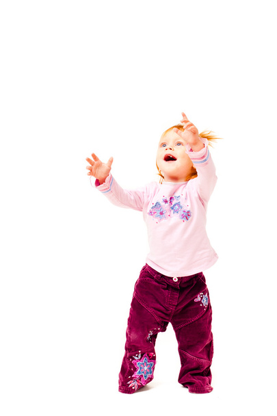 Little girl with her hands up on a white background - Photo, image