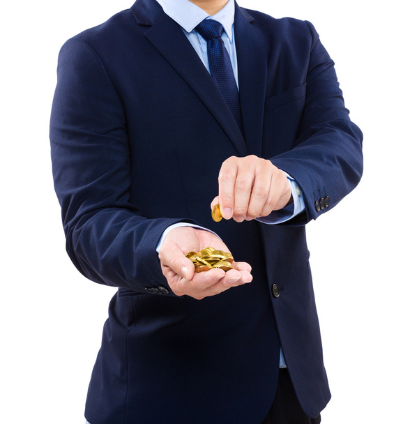Бізнесмен тримає золоту монету
 - Фото, зображення