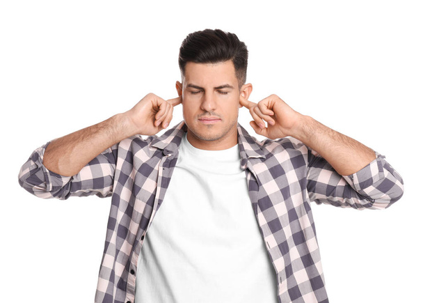 Man covering ears with fingers on white background - Foto, Imagen