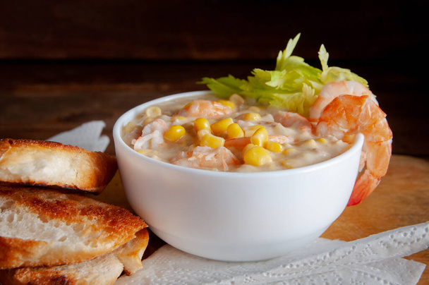 Bowl of homemade corn chowder soup with potatoes, carrots and shrimp.English shrimp chowder soup - Φωτογραφία, εικόνα