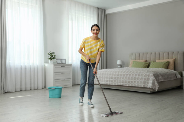 Woman cleaning floor with mop at home - Valokuva, kuva