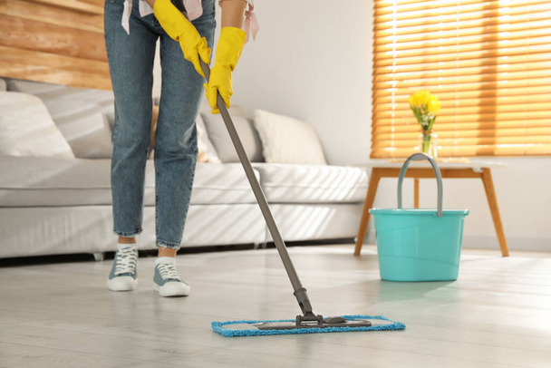 Woman cleaning floor with mop at home, closeup - Fotoğraf, Görsel