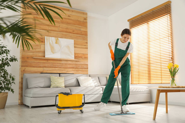 Woman cleaning floor with mop at home - Fotografie, Obrázek