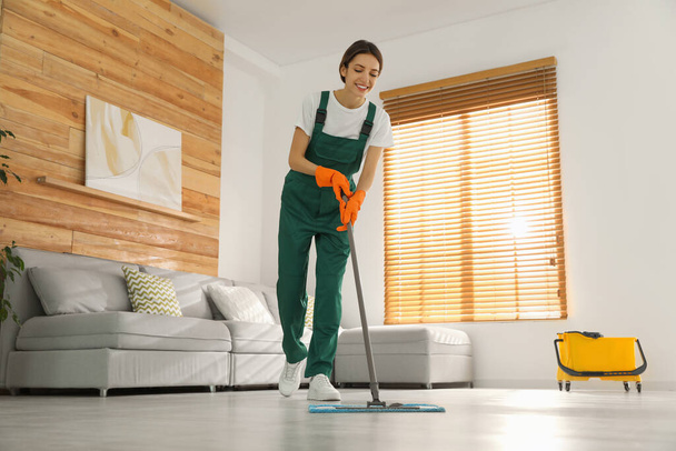 Woman cleaning floor with mop at home - 写真・画像