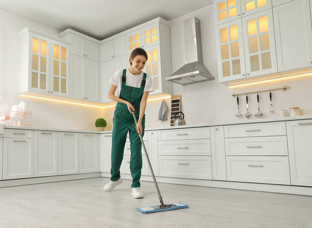 Woman cleaning floor with mop at home - Foto, Bild