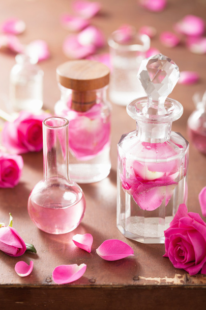 alchemy and aromatherapy set with rose flowers and flasks  - Photo, Image