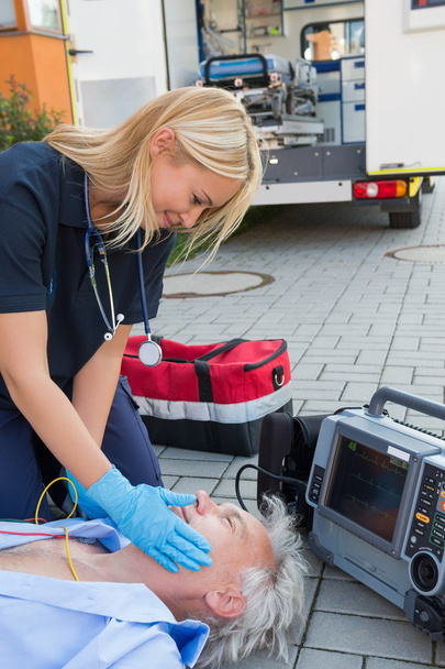 Paramedic helping injured patient on street - Fotoğraf, Görsel
