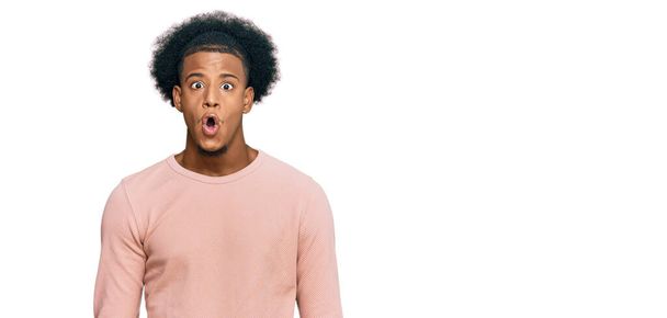 African american man with afro hair wearing casual clothes afraid and shocked with surprise expression, fear and excited face.  - Photo, Image