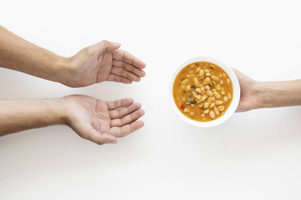 hand giving soup bowl needy person. Resolution and high quality beautiful photo - Photo, Image