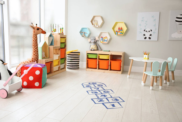 Blue hopscotch floor sticker in playing room - Foto, afbeelding