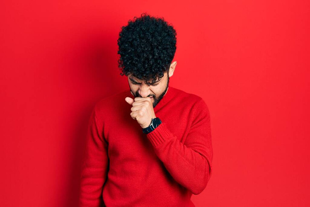 Young arab man with beard wearing casual red sweater feeling unwell and coughing as symptom for cold or bronchitis. health care concept.  - Fotografie, Obrázek