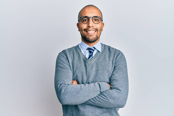 Hispanic adult man wearing glasses and business style happy face smiling with crossed arms looking at the camera. positive person.  - Photo, Image