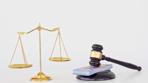 The scales of justice and the judge hammer with the money placed on the board also have a white background. - Footage, Video