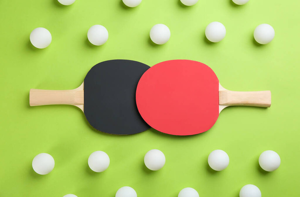Ping pong rackets and balls on green background, flat lay - Фото, зображення