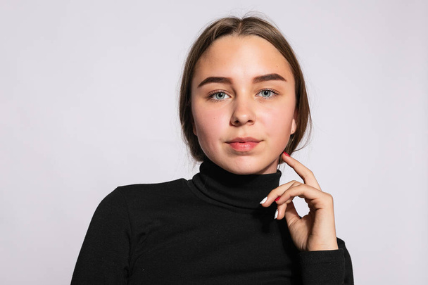Trendy beautiful hipster girl. Photo of positive young nice woman in black knee-high socks with white background. looks at the camera. - Valokuva, kuva