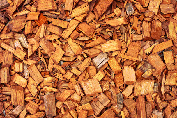 orange wooden splinters close-up. Decorative wood chips texture. Natural material pattern of red wooden pieces of tree bark. Full filled frame picture above view.  - Photo, Image