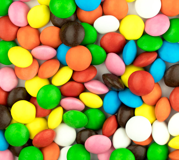 Szivárvány fényes cukorka. Vidám színes gyerekek finom háttér - Fotó, kép