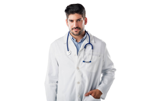 Studio portrait of male doctor standing at isolated white background while looking at camera and smiling. Copy space.  - Photo, image