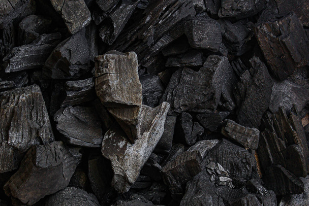 black coal background. charcoal woody black. lot of wood - 写真・画像