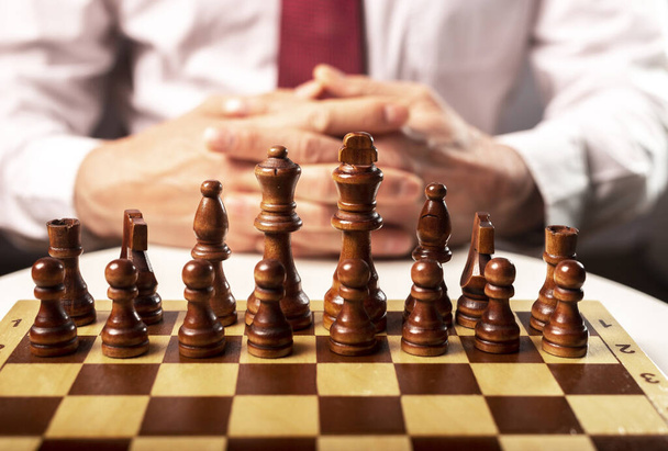 Business start up and control concept. Male hands and chess board under control of boss. - 写真・画像